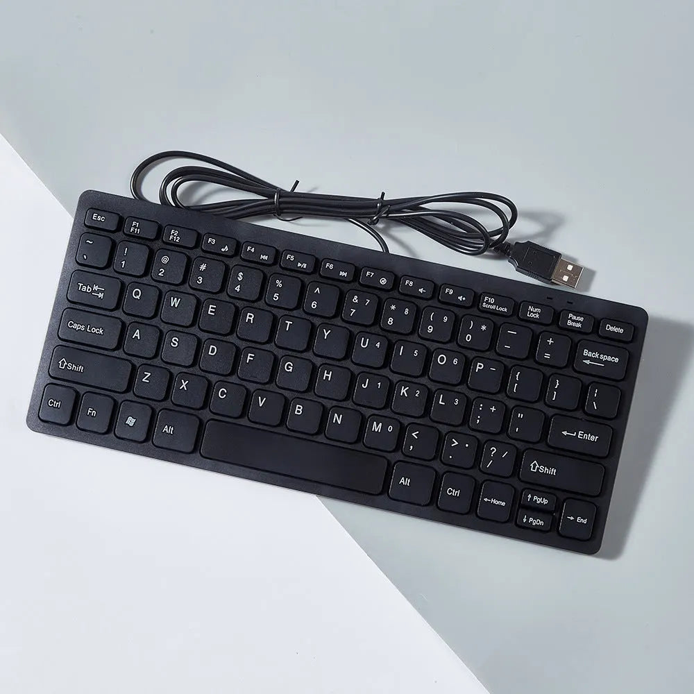 Mini wired USB computer keyboard in black, white, pink, or blue colour options.