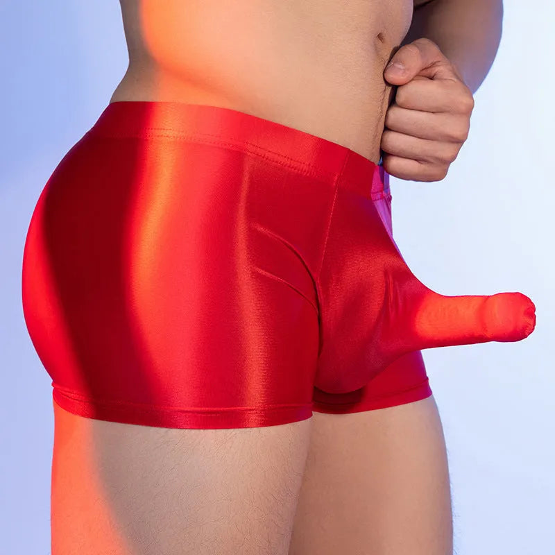 Seamless men's boxers in red nylon fabric with mid waist and elephant nose pouch design.