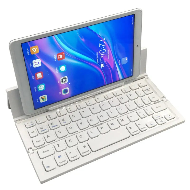 Black folding Bluetooth keyboard with numeric pad next to tablet