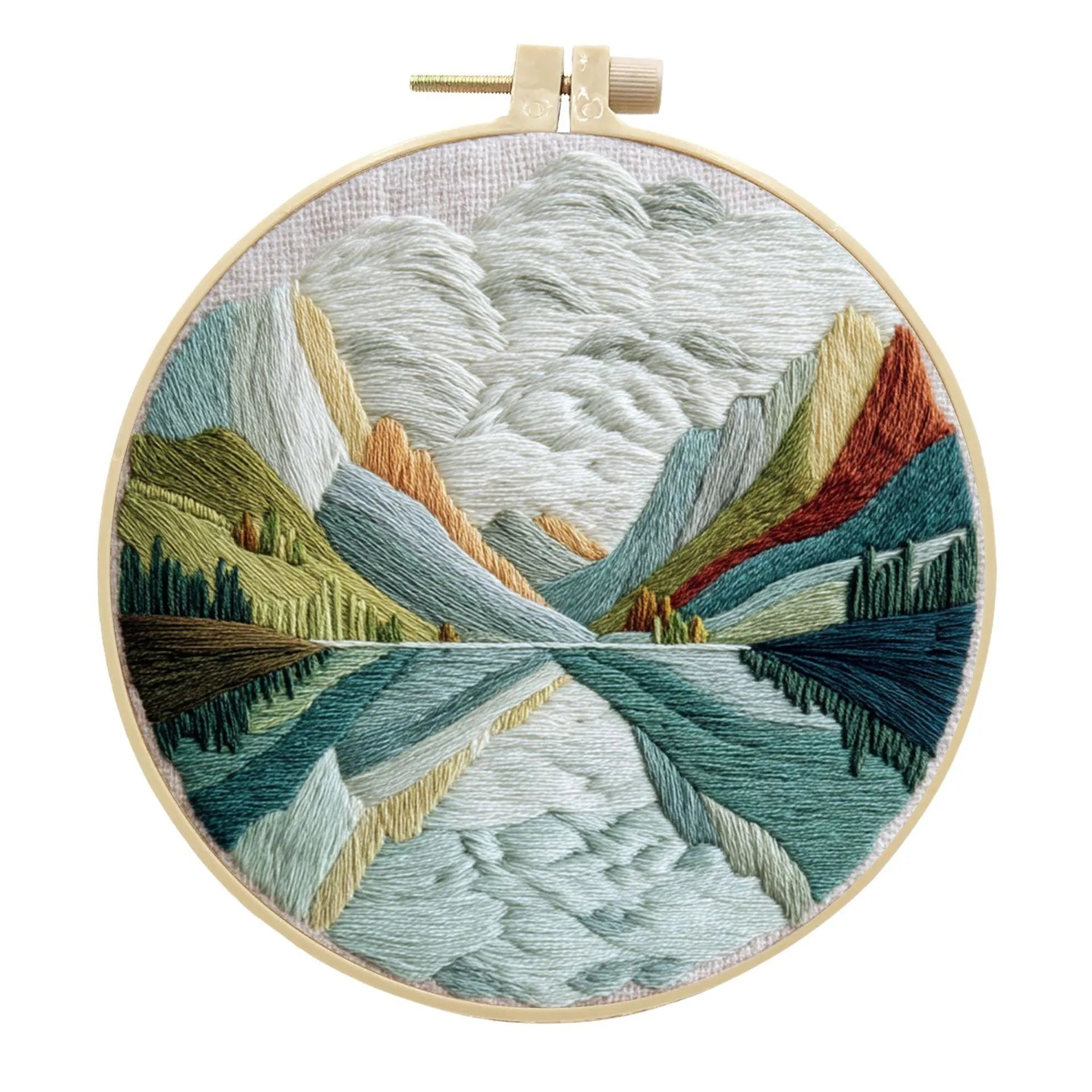 DIY landscape embroidery kit with cotton fabric, bamboo frame, threads and needles arranged for crafting