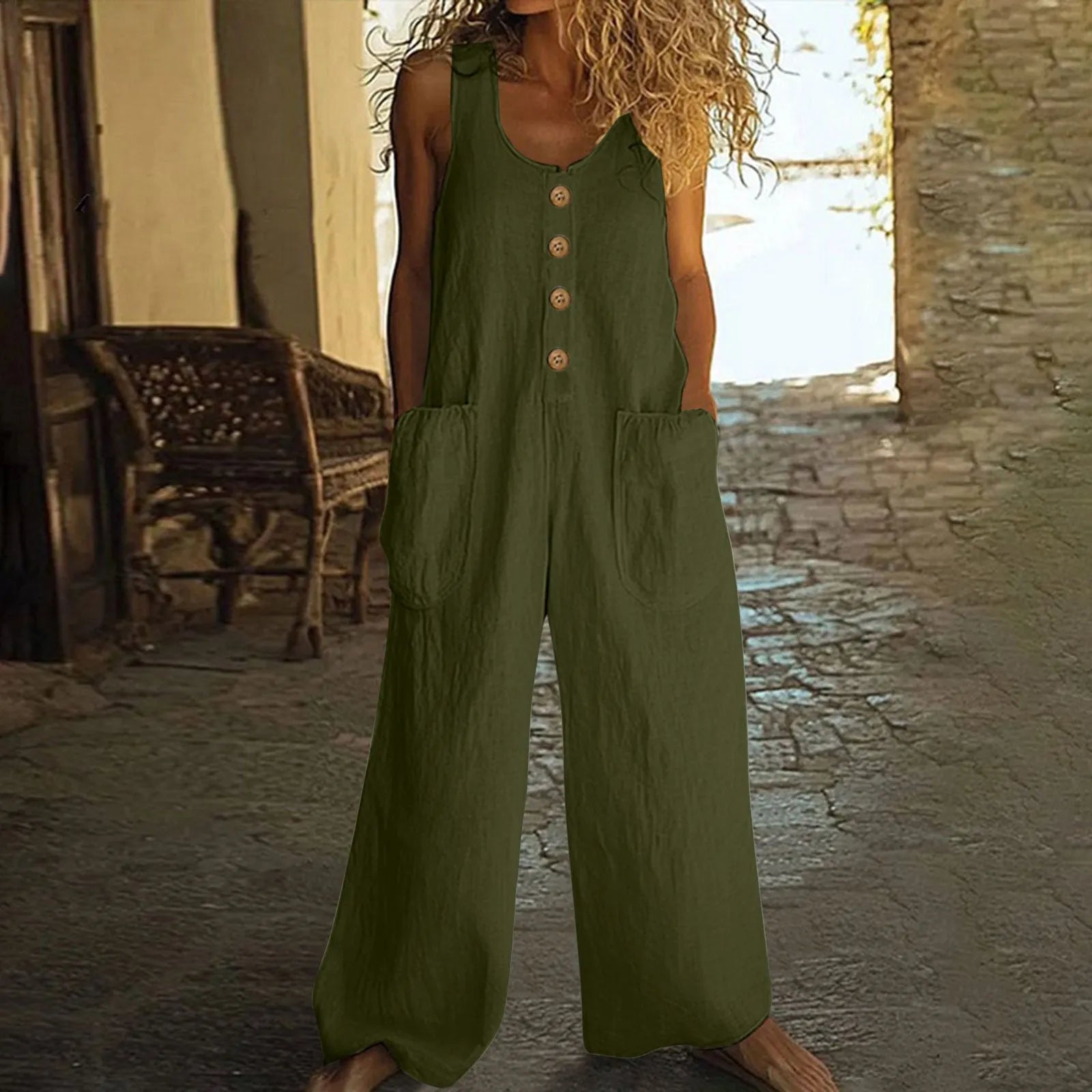 Sleeveless wide leg cotton jumpsuit in peacock green colour showing loose fit and pocket detail.
