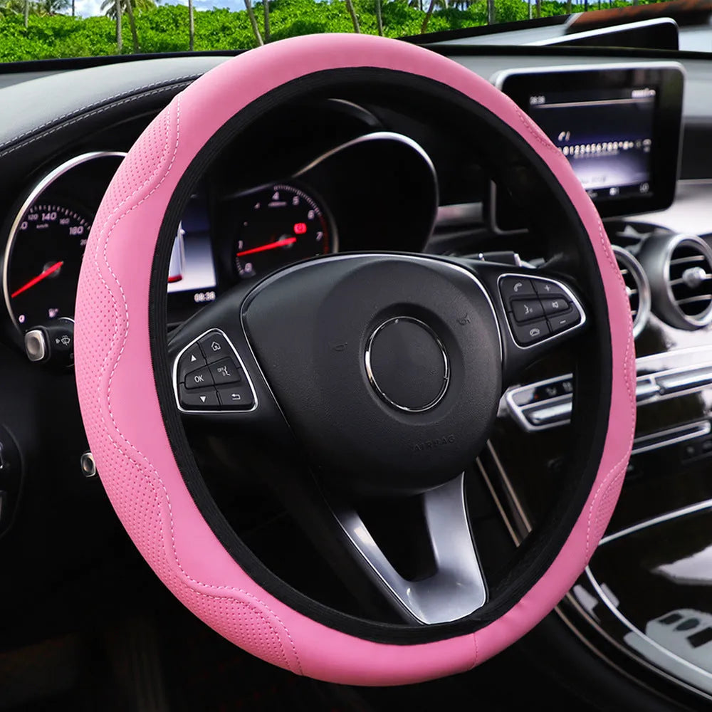 Black elastic steering wheel cover with a corrugated texture, stretched to show its fit.