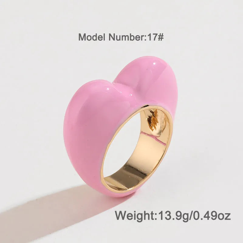 A heart-shaped three-dimensional enamel ring in zinc alloy, shown in one of four available colours.