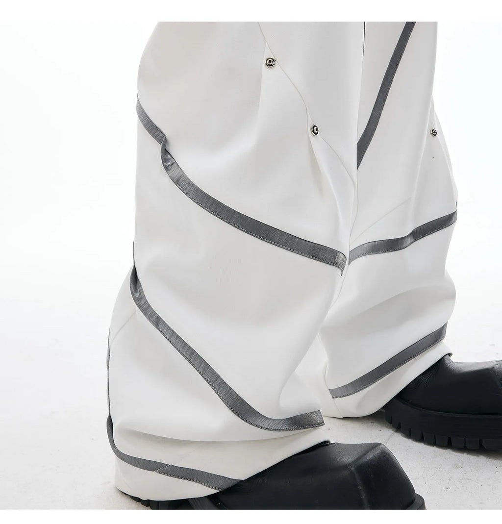 Men's polyester trousers with three-dimensional cut, metal striped rivets, and pleated front.