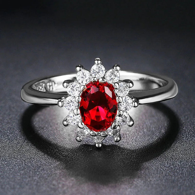 Women's copper floral ring with inlaid zirconium detail in green, blue, or red.