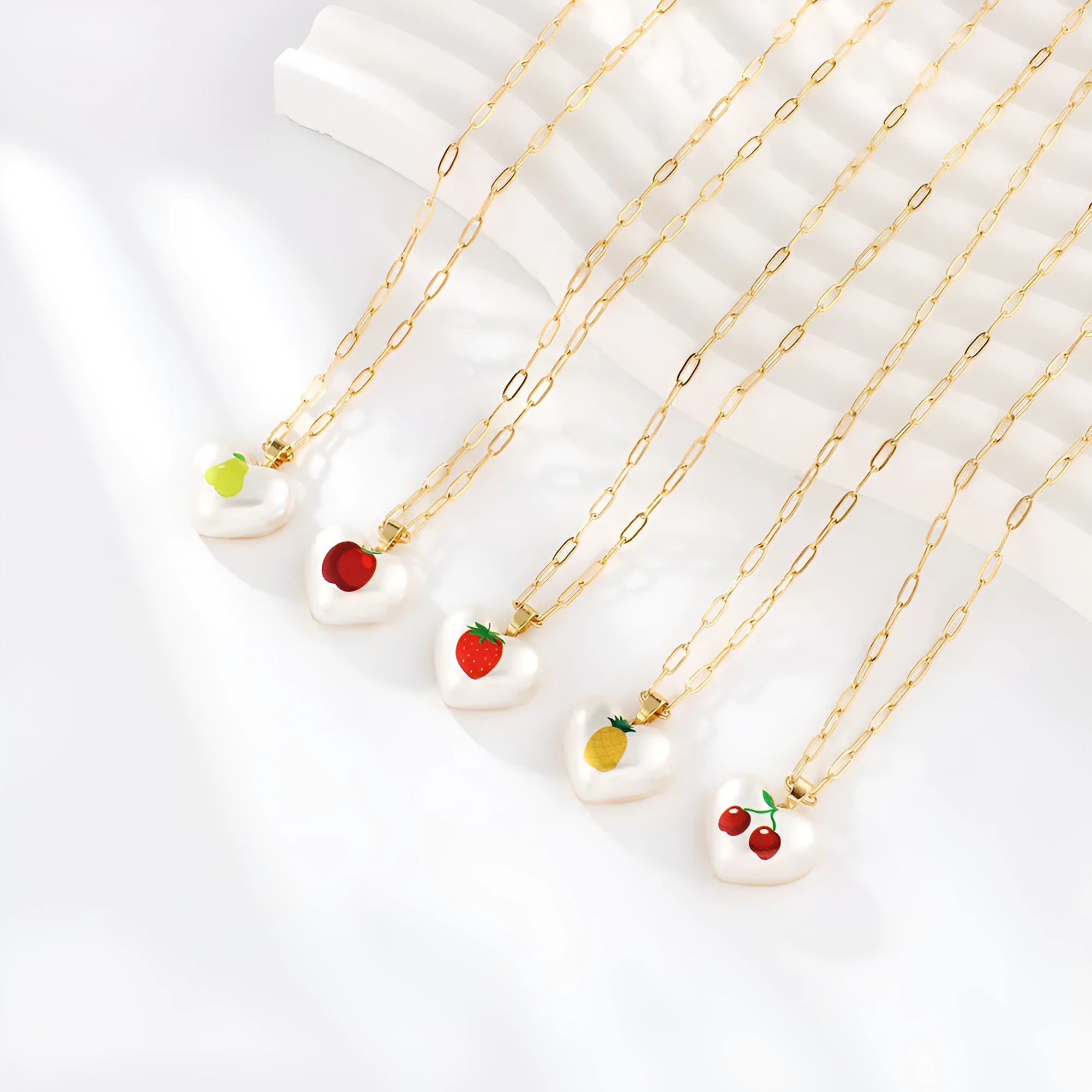 Adjustable girls necklace with a choice of apple, cherry, pear, pineapple, or strawberry heart-shaped pendant.