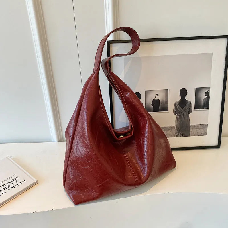 Casual soft PU leather large capacity shoulder bag in street trend style.