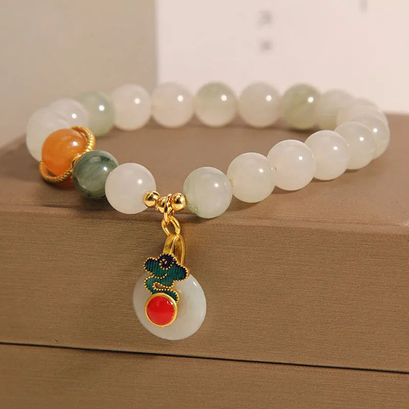 Women's ice jade crystal bracelet with pearl accents and a jade buckle on a white background.