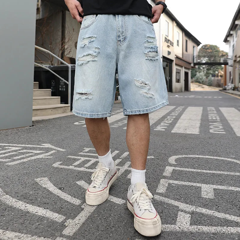 Light blue ripped denim shorts with a loose straight-leg fit on a mannequin.