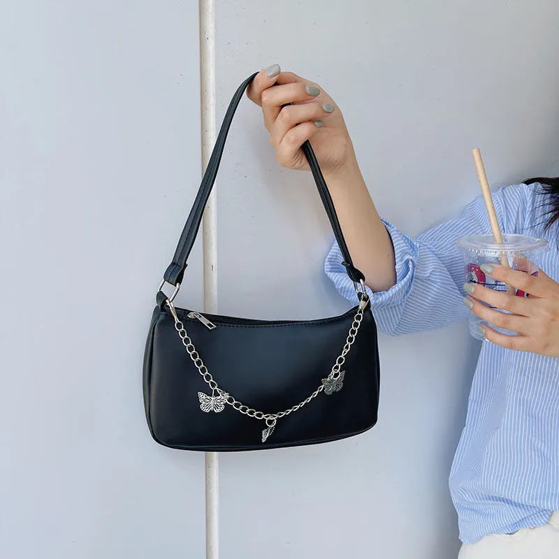 Women's black PU butterfly chain underarm handbag with crossbody strap, shown in a horizontal square shape.