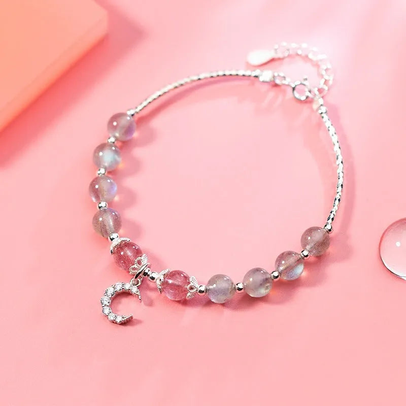 Natural moonstone handmade bracelet with crescent moon charm on wrist showing adjustable clasp