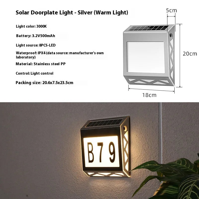 Black solar-powered doorplate light with LED illumination for house numbers measuring 180x50x200mm