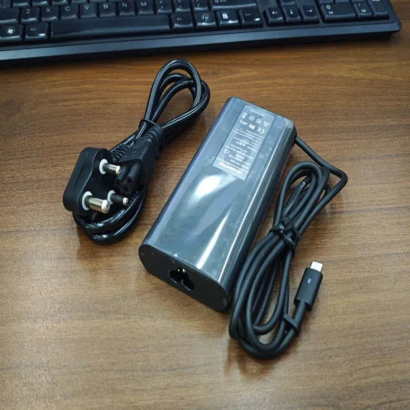 Black 65W Type-C laptop power adapter with multiple international power plugs
