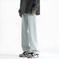 Men's light blue straight leg jeans with a button waist closure on a white background.