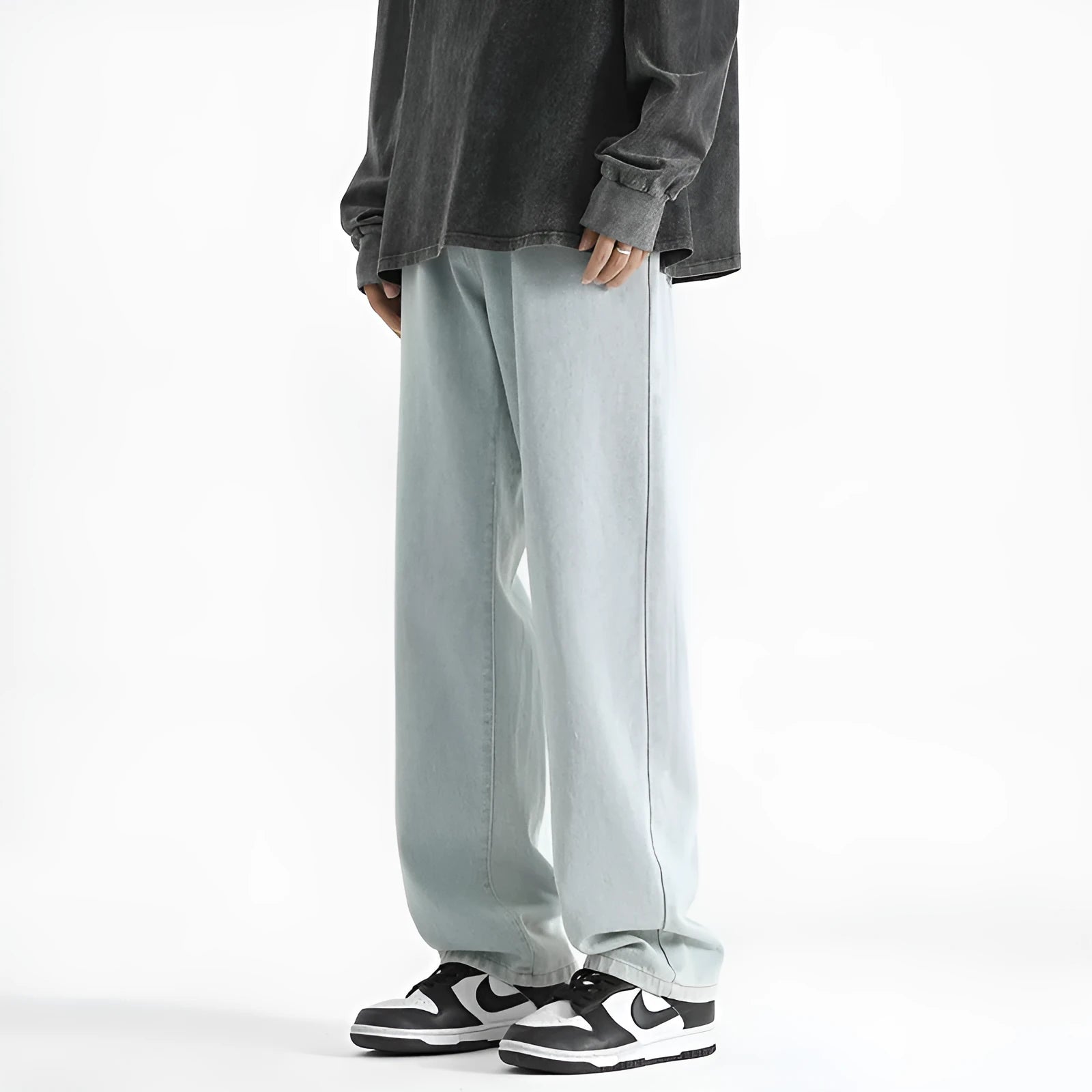 Men's light blue straight leg jeans with a button waist closure on a white background.