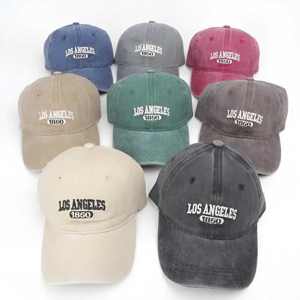 Retro washed distressed embroidered peaked cap with adjustable strap on a conical crown.