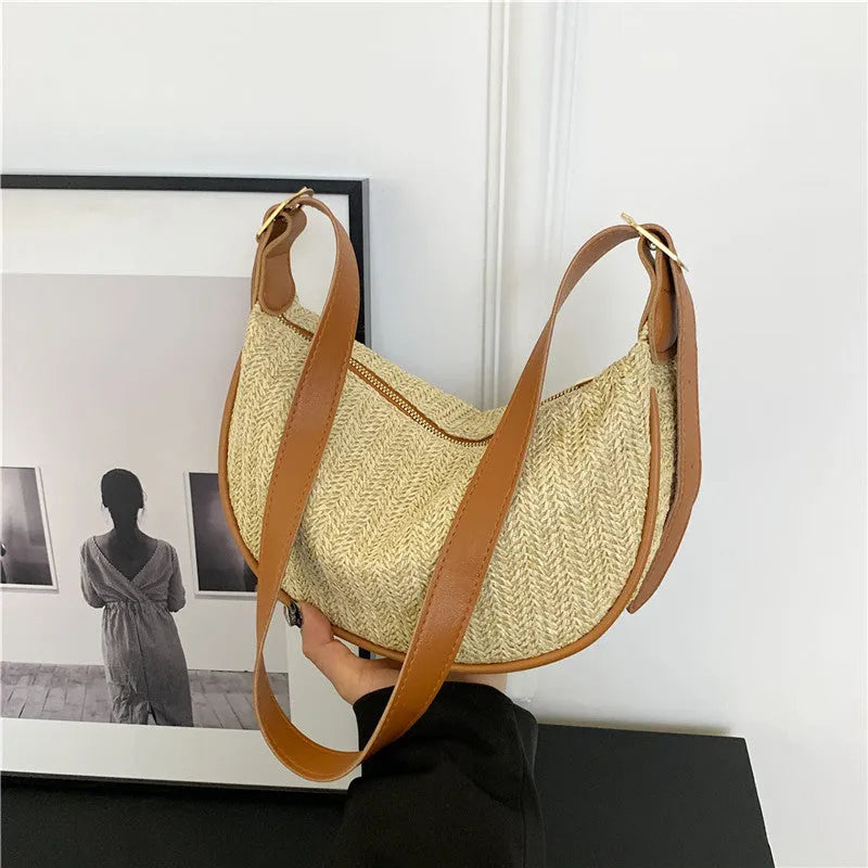 Women's straw woven crossbody bag showing knitted weaving texture and internal phone pocket