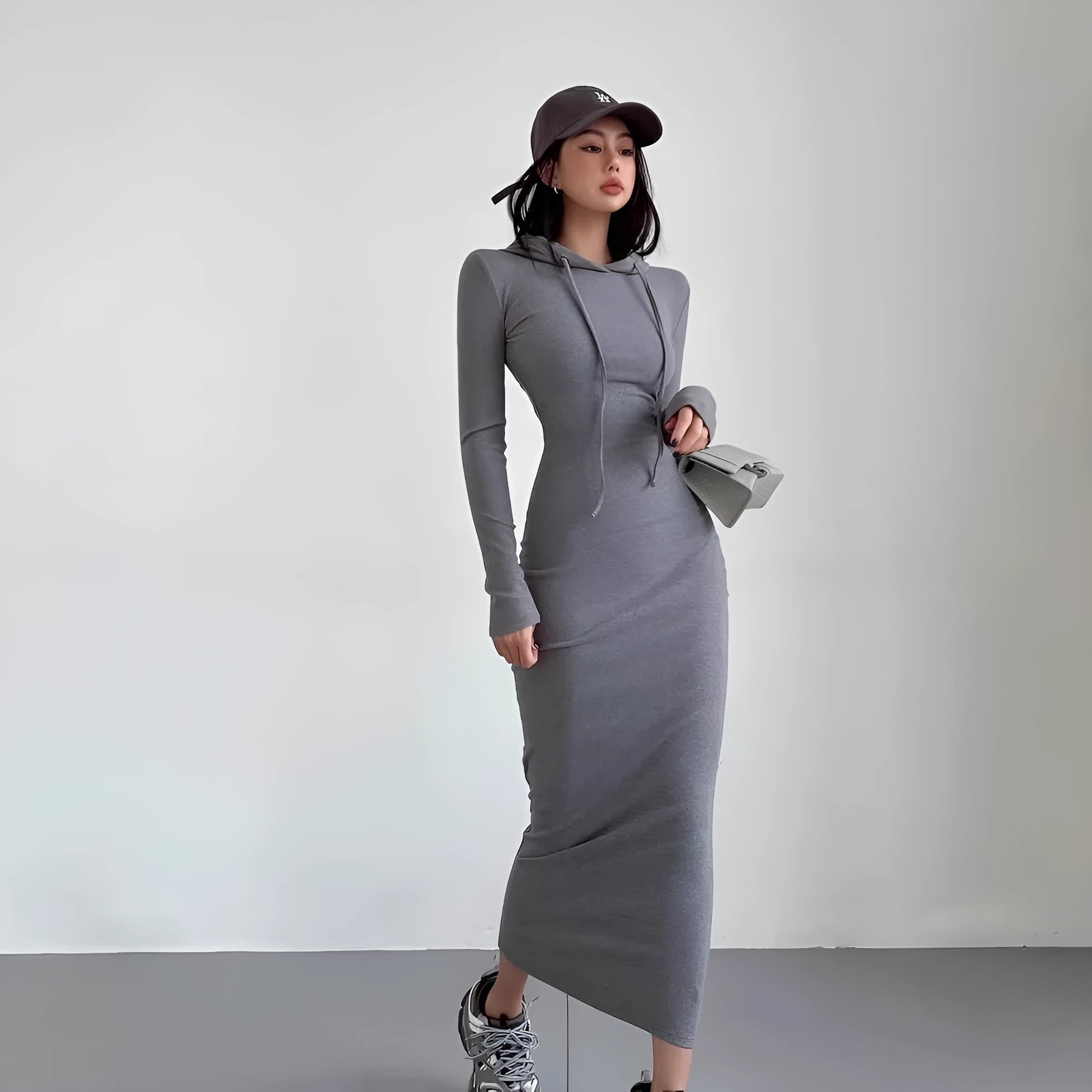 Women's long sleeve hooded sheath dress in grey with over-the-knee length and high waist.