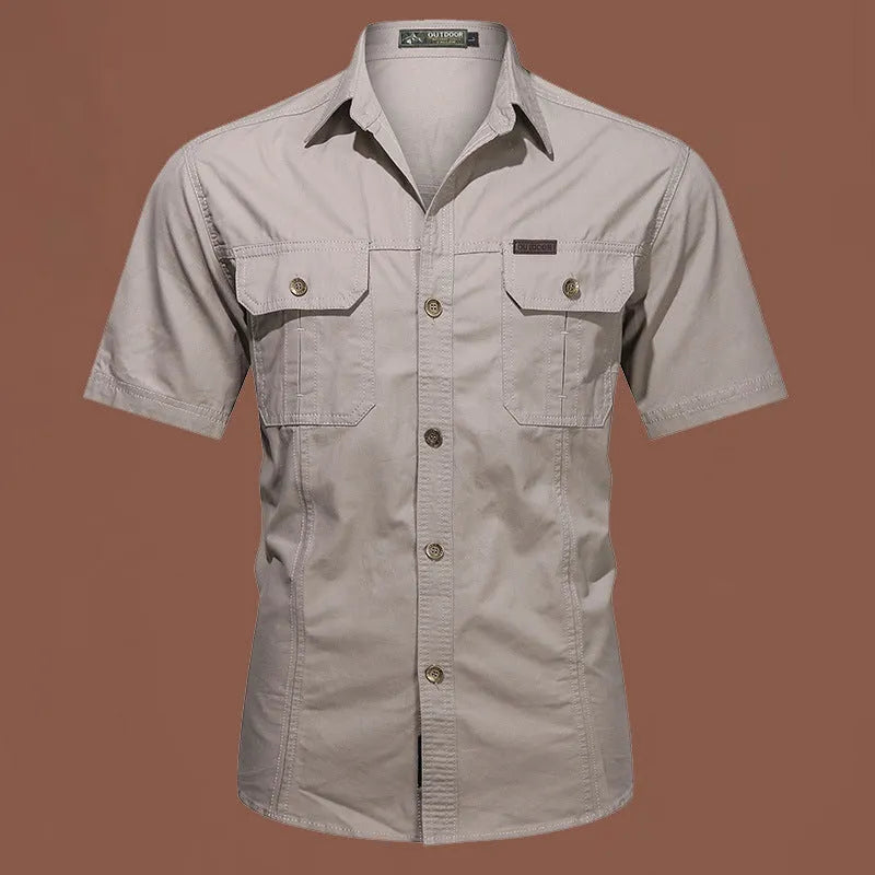 Men's loose-fitting short sleeve cotton work shirt in army green, laid flat.