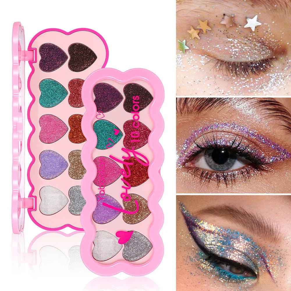 Heart-shaped case open to show ten eyeshadow pans in white, beige, pink, purple, brown, blue, black, royal blue, maroon, and coral.