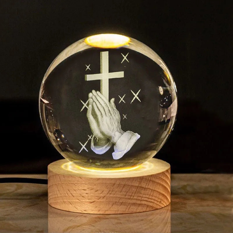 White crystal ball with cross and religious symbols on wooden LED base desk ornament