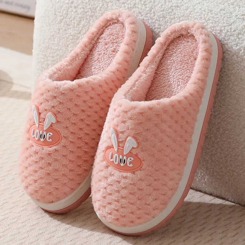 Rabbit plaid design women's house slippers in artificial fur with a flat heel and rubber sole.