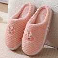 Rabbit plaid design women's house slippers in artificial fur with a flat heel and rubber sole.