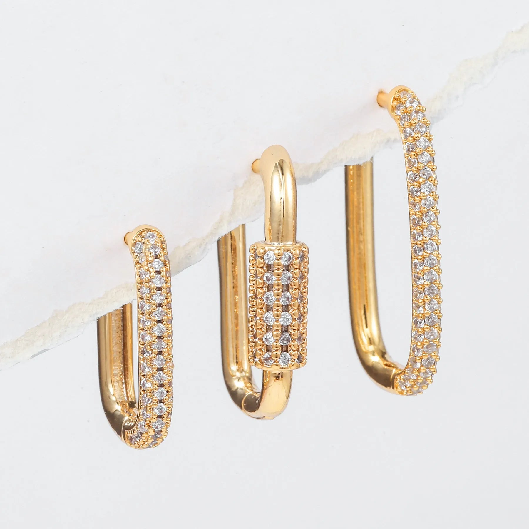 Three geometric copper ear clips with micro inlaid zircon treatment in gold and white colours