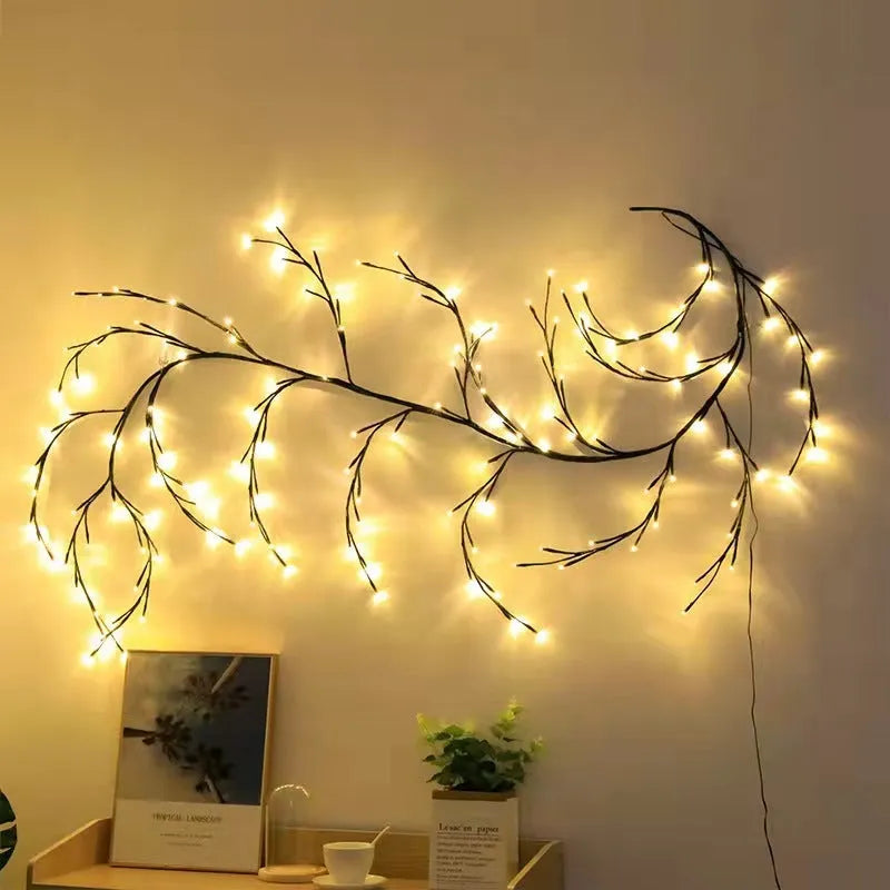 Flexible birch bark textured LED willow vine garland bent into shape with warm white lights.