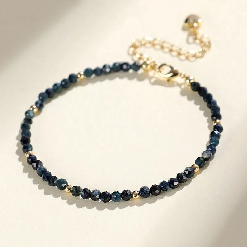 Blue tourmaline spacer bead bracelet with 3mm cut beads and blue gold accents