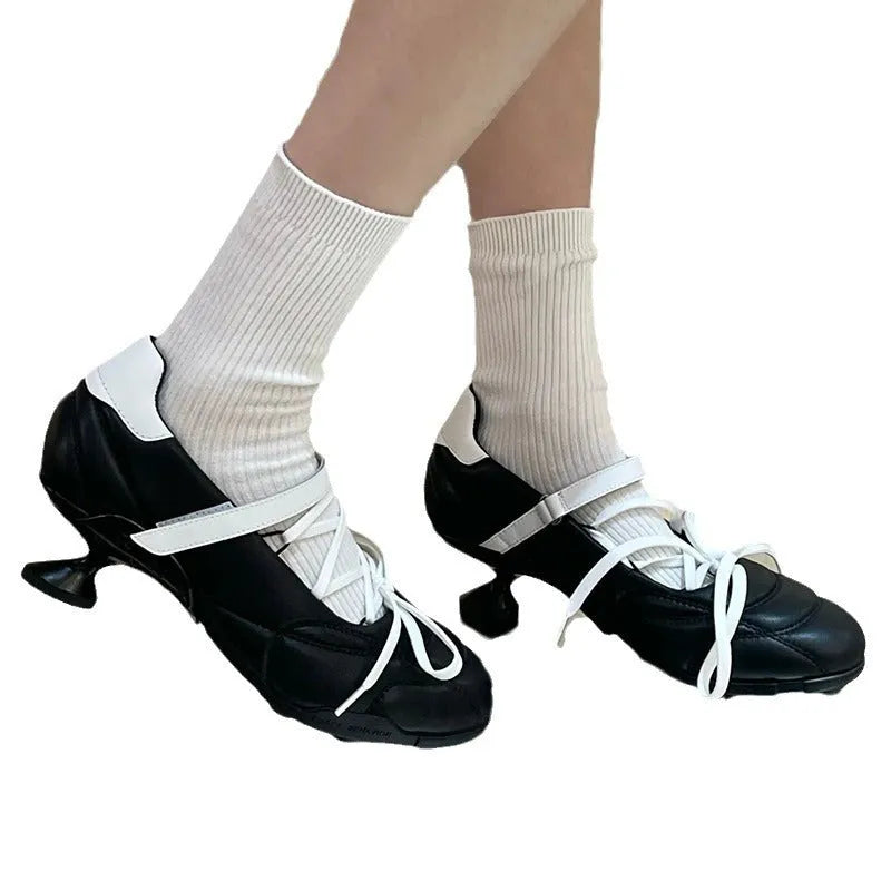 Women's silver lace-up sports shoes with a bow detail and round toe on a mid heel.