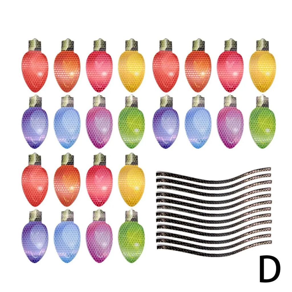 Set of magnetic reflective Christmas light bulb and wire stickers on a metal surface.