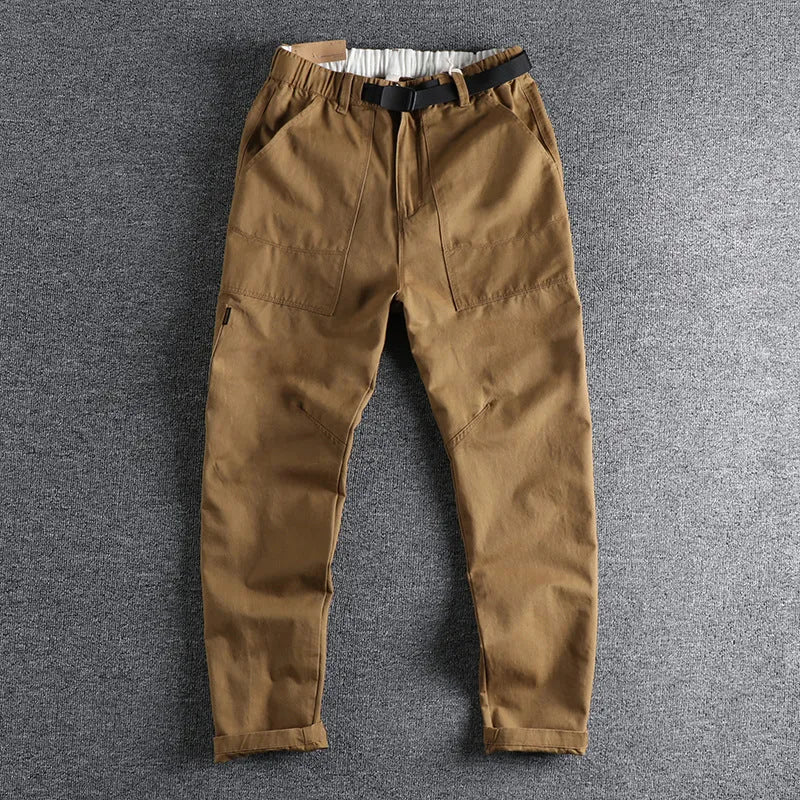 Men's khaki and dark blue cotton casual trousers with a mid-waist fit and zip fly.