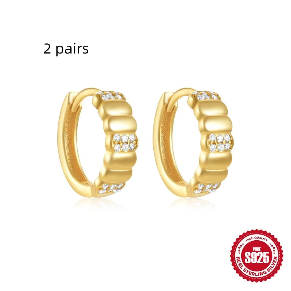 Sterling silver geometric stud earrings with small round design elements in gold or silver finish