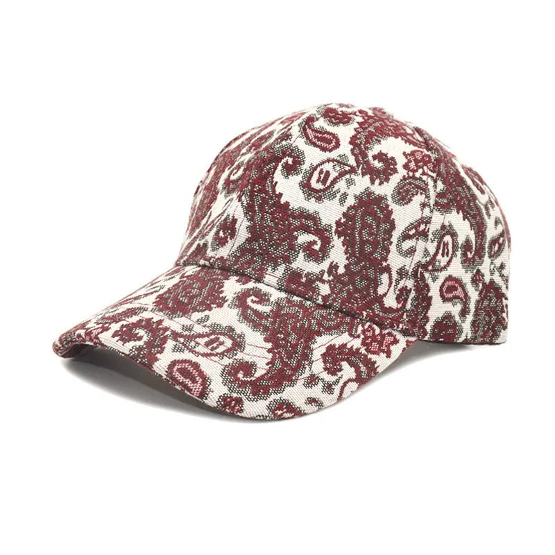 Blue polyester baseball cap with a white paisley pattern, showing the dome crown style.