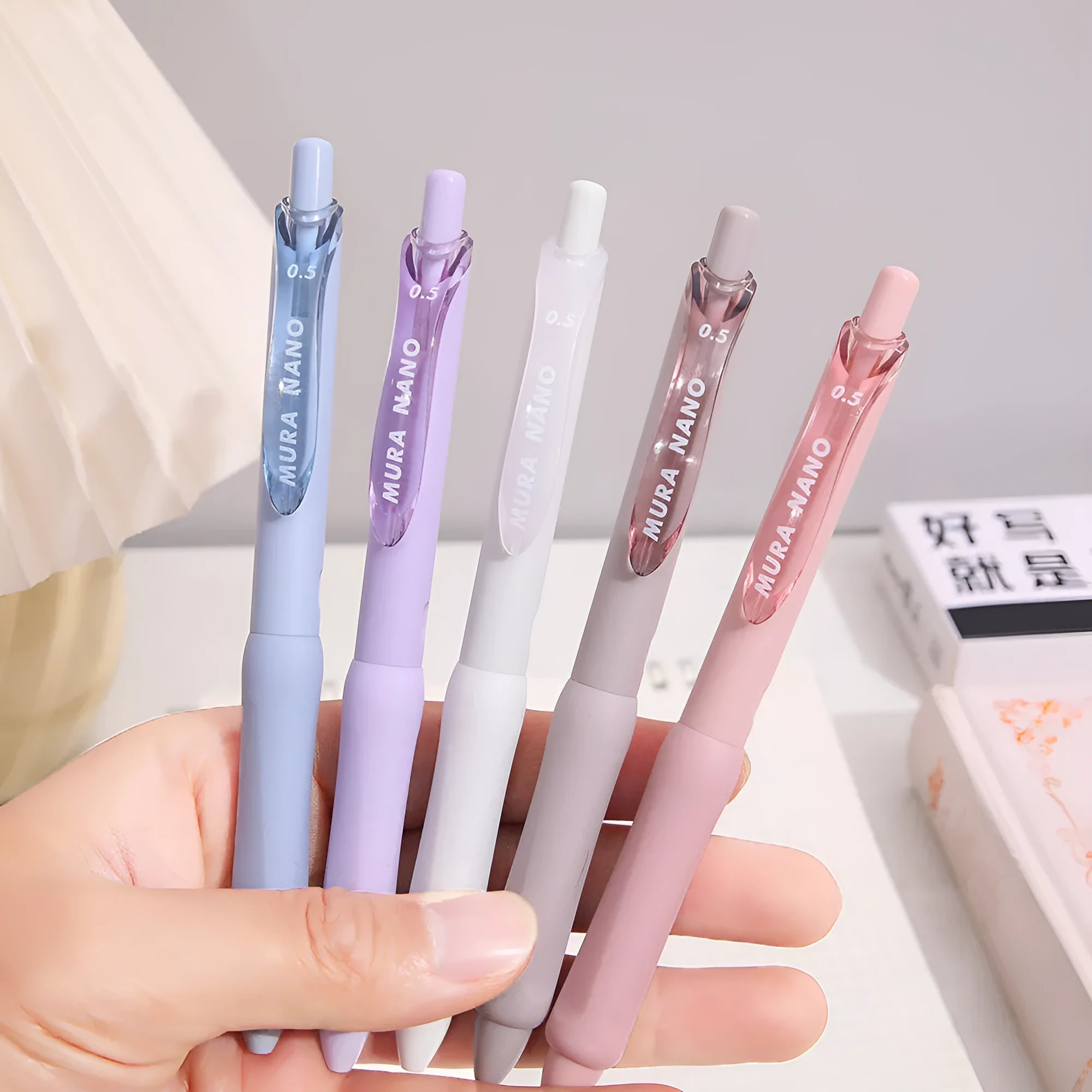Macaron Colour press gel pen with 0.5mm tip in smoked white, brown, or pink ink options.