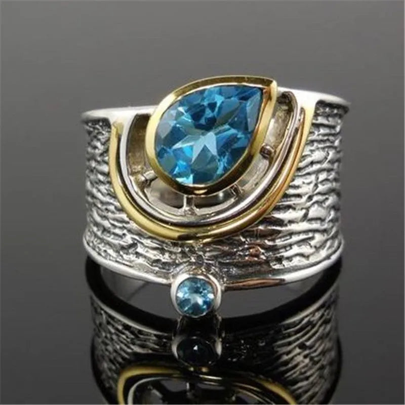 Close-up of a women's blue zircon alloy ring with Chinese style drop shape design and rhinestone inlay.