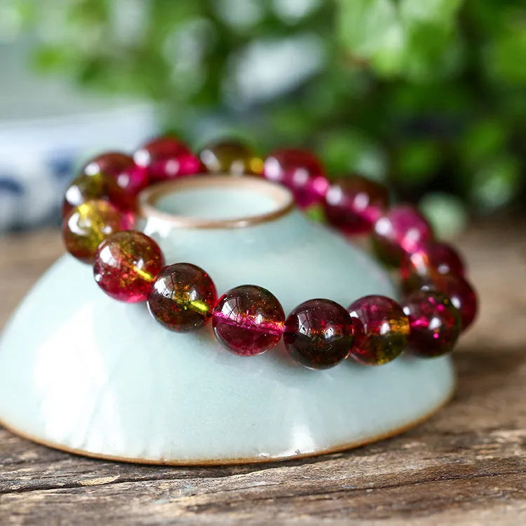 Handmade watermelon red crystal bracelet for women, shown in a casual style with pastoral elements.