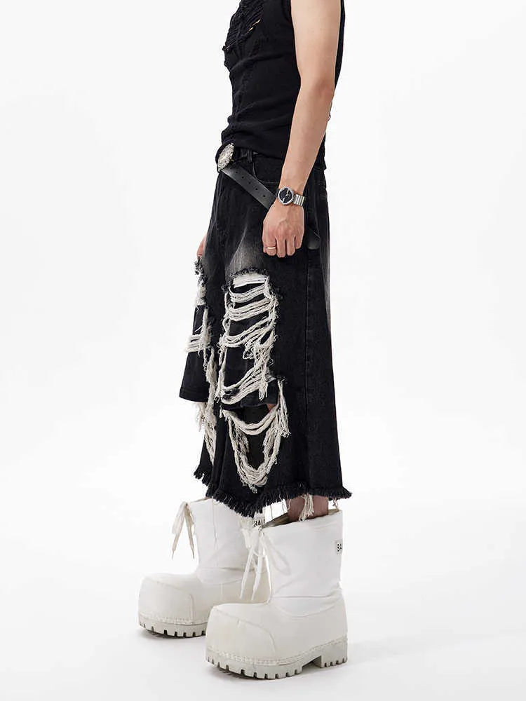 Black wide-leg cropped jeans with ripped patch detail on the legs, showing a mid-high waist and loose fit.