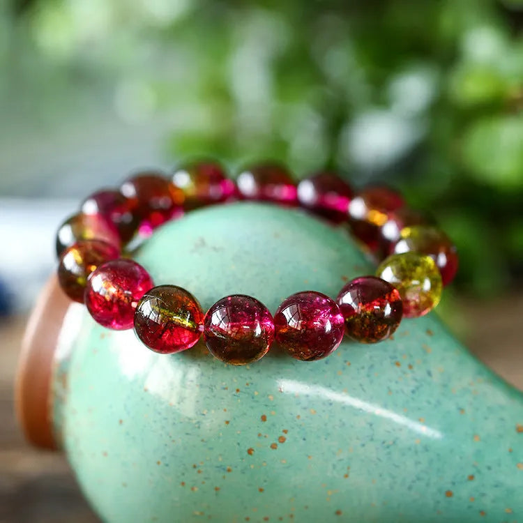 Handmade watermelon red crystal bracelet for women, shown in a casual style with pastoral elements.