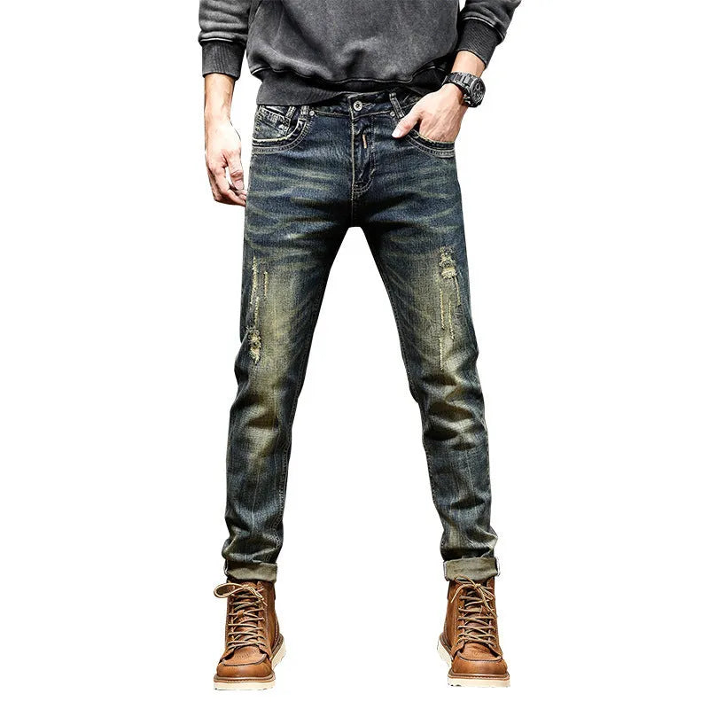 Men's skinny fit retro blue jeans with a zip fly on a plain background
