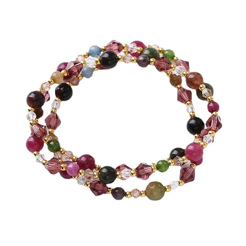 Close-up of a handmade three-stone crystal bracelet with an adjustable cord, shown in a choice of gemstone colours.