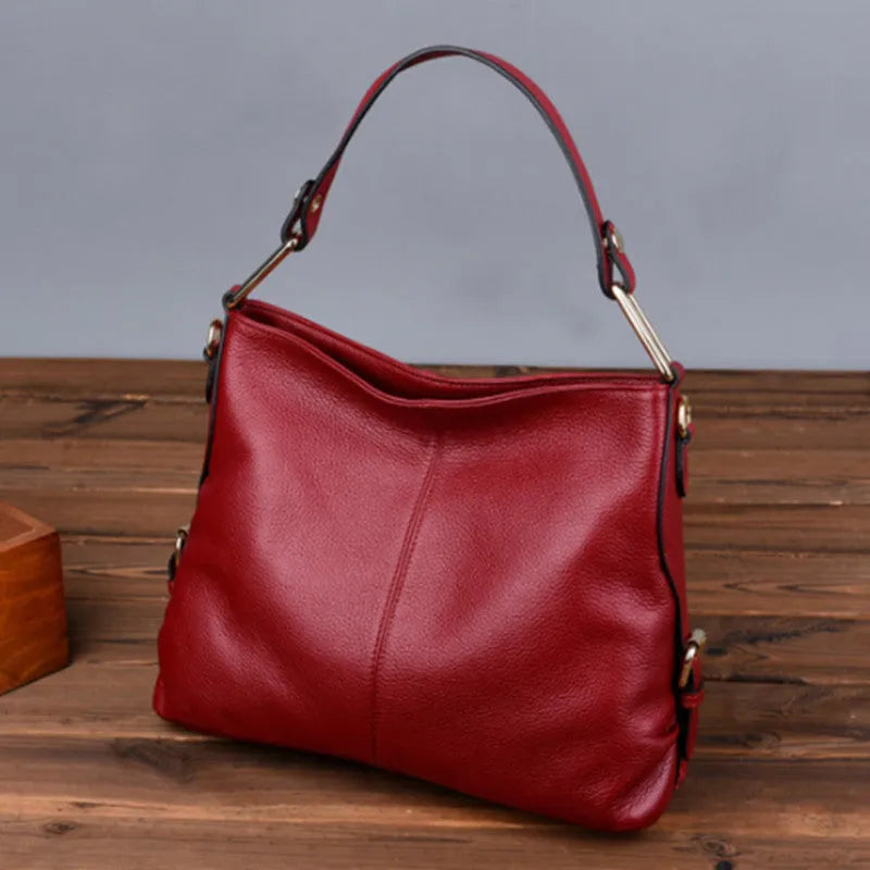 Genuine leather vertical square crossbody bag showing internal zipper compartments and external sandwich pocket