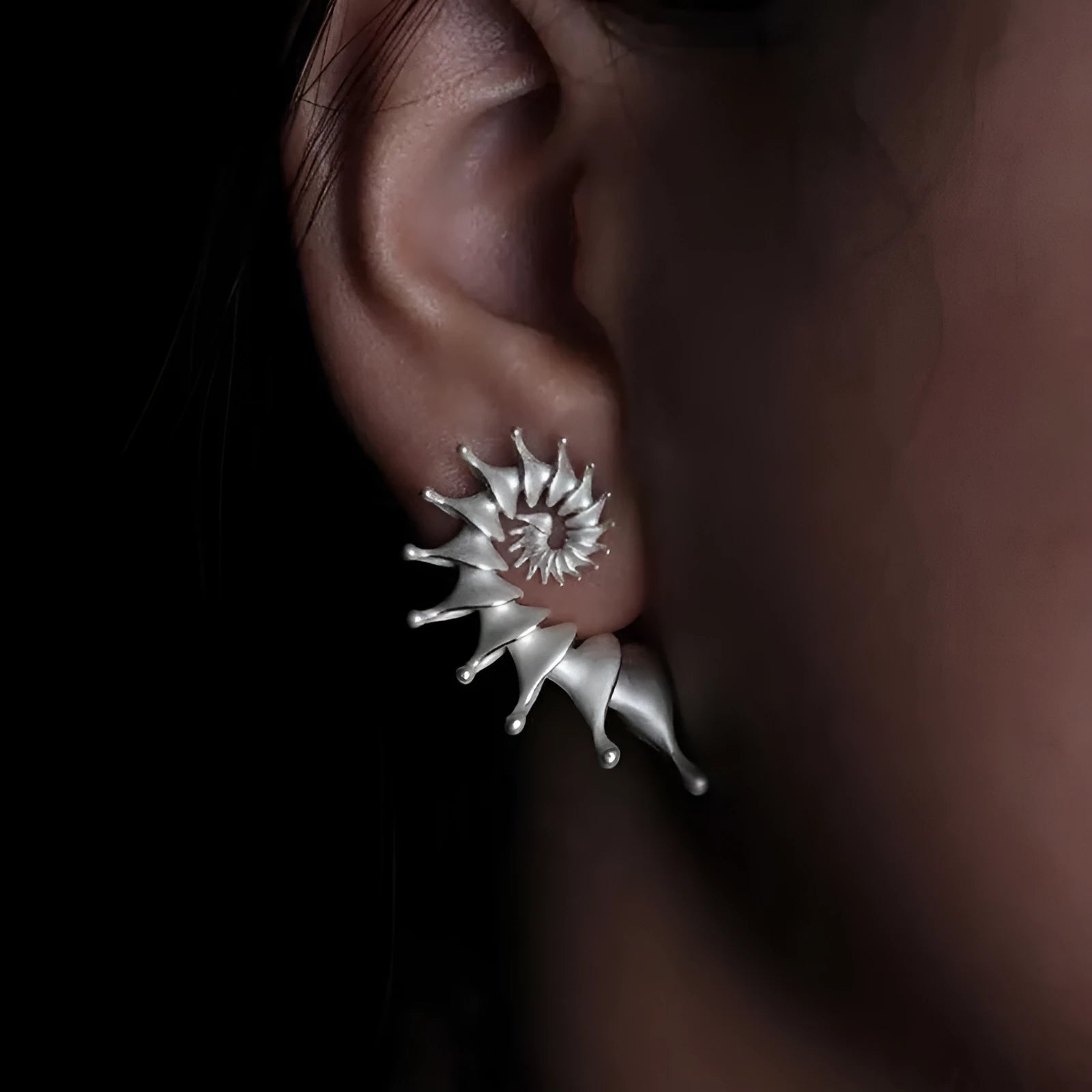 A pair of conch-shaped stud earrings with a three-dimensional matte finish in an irregular simple style.