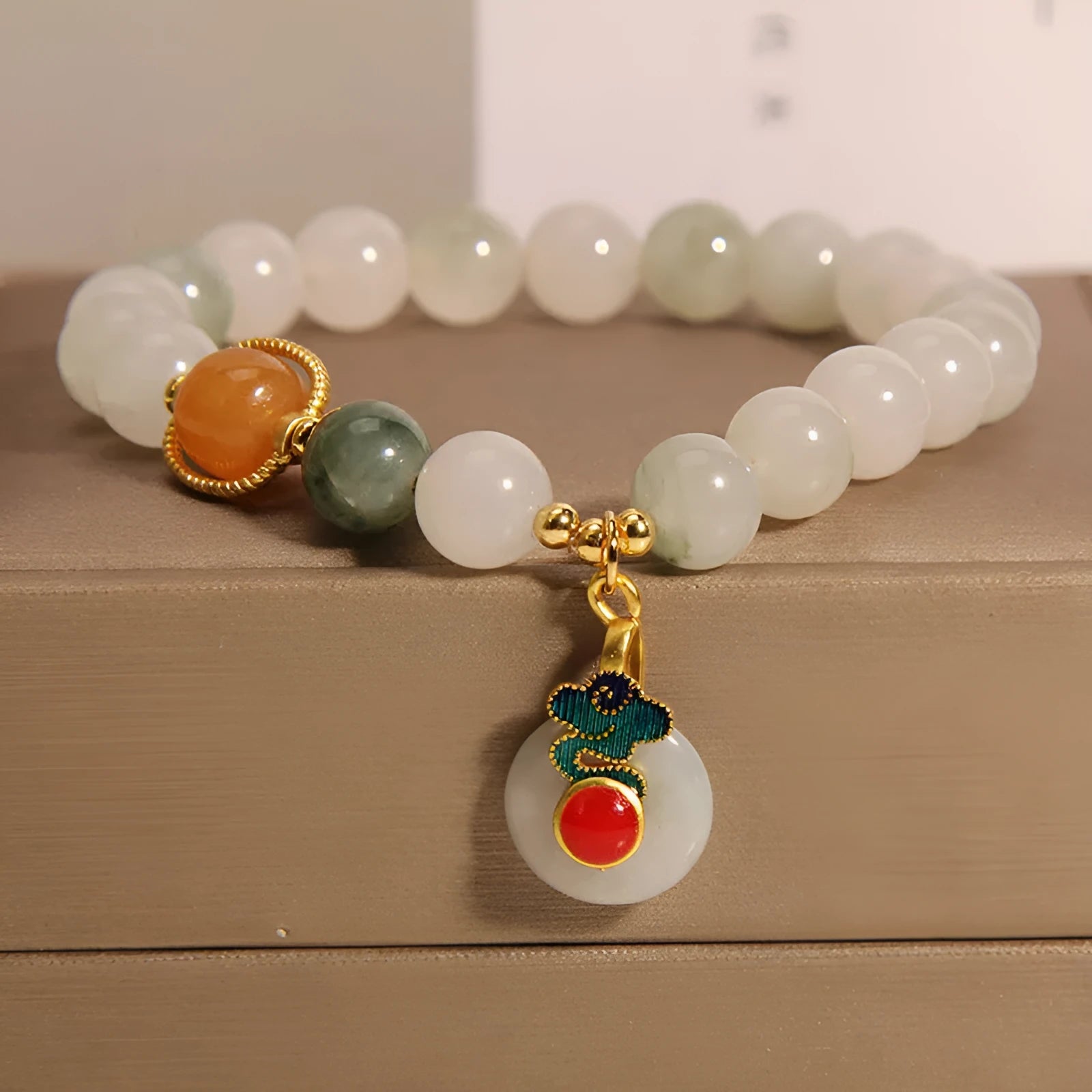 Women's ice jade crystal bracelet with pearl accents and a jade buckle on a white background.
