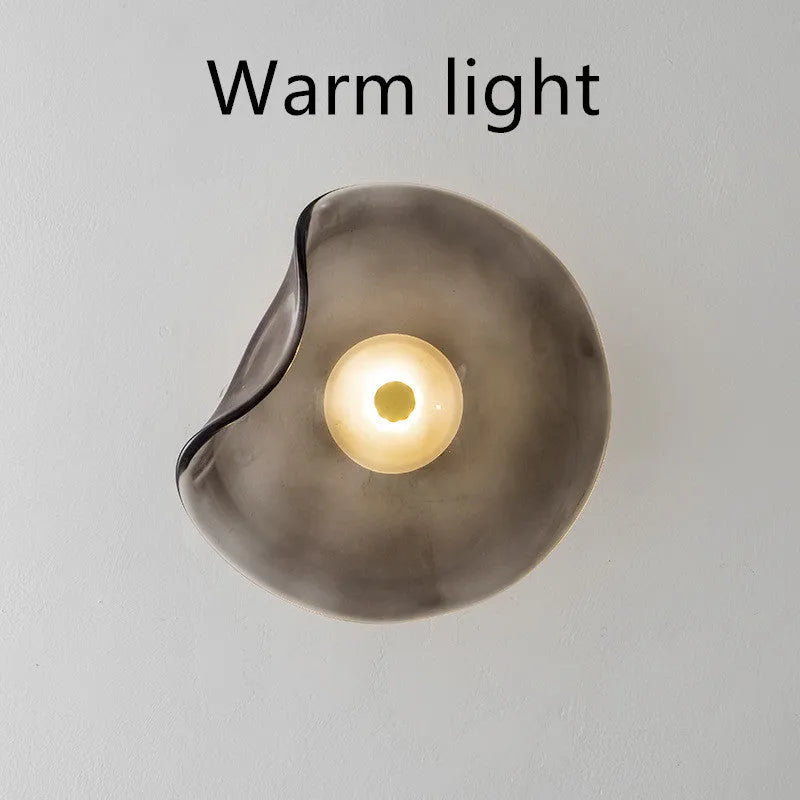 Round decorative wall lamp with glass shade for bedroom bedside lighting