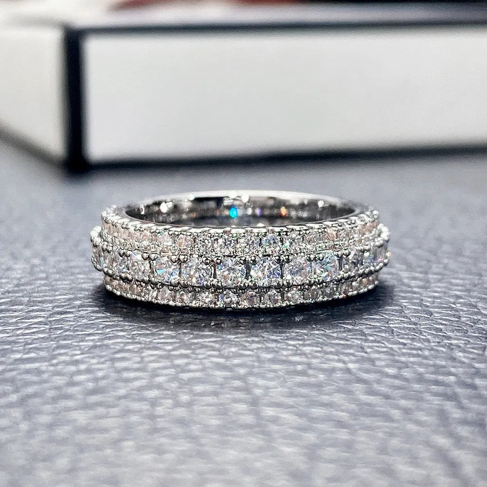 Geometric triangle design engagement ring with zircon stone inlay, shown in different metal plating finishes.