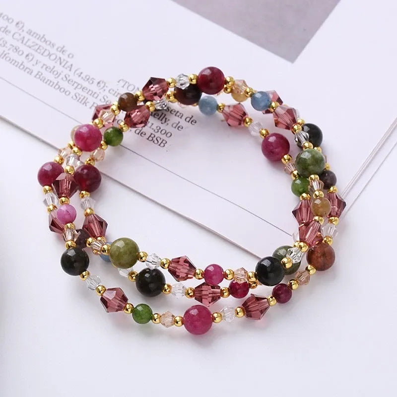Close-up of a handmade three-stone crystal bracelet with an adjustable cord, shown in a choice of gemstone colours.