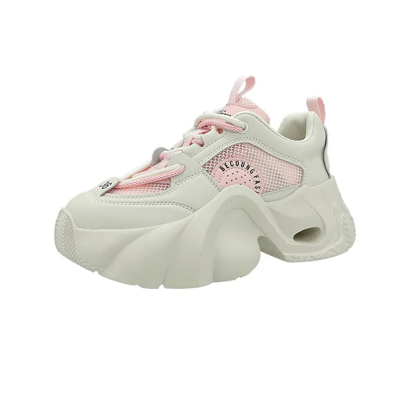 Women's beige platform sneakers with a cross-strap design and thick sole.