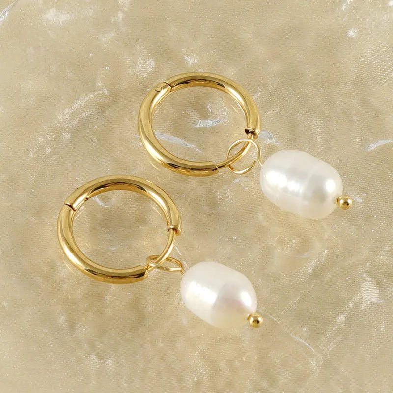 Geometric gold stainless steel earrings with pearl accents on white background